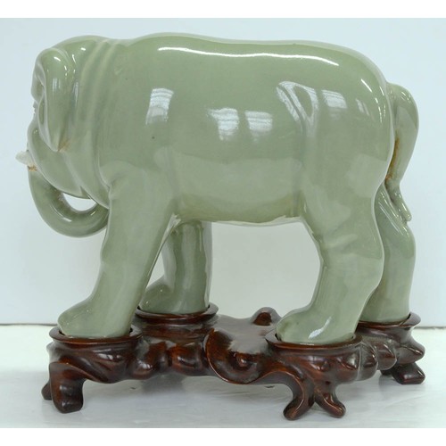 200 - A Chinese celadon model of an elephant,  20th c, 18cm h, wood stand (2)The collection of C. W. Brigg... 