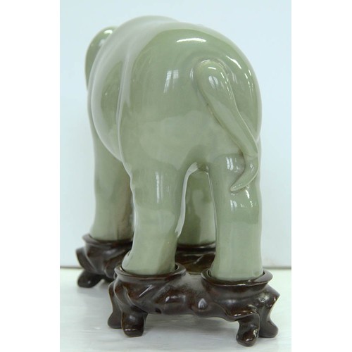 200 - A Chinese celadon model of an elephant,  20th c, 18cm h, wood stand (2)The collection of C. W. Brigg... 