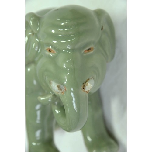 200 - A Chinese celadon model of an elephant,  20th c, 18cm h, wood stand (2)The collection of C. W. Brigg... 