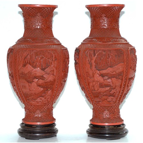 271 - A pair of Chinese cinnabar lacquer vases, c1900, carved with four panels of immortals and other figu... 