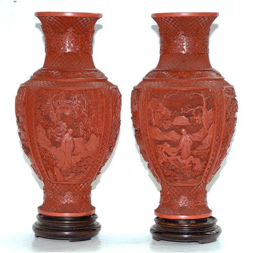 271 - A pair of Chinese cinnabar lacquer vases, c1900, carved with four panels of immortals and other figu... 