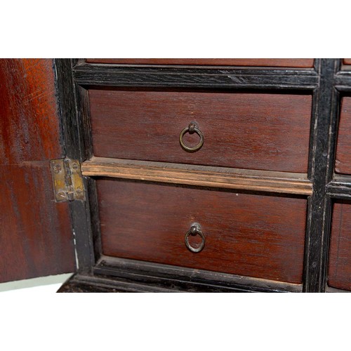 301 - A mahogany and ebony collector's cabinet, 19th c, fitted with sixteen drawers with brass wire ring p... 