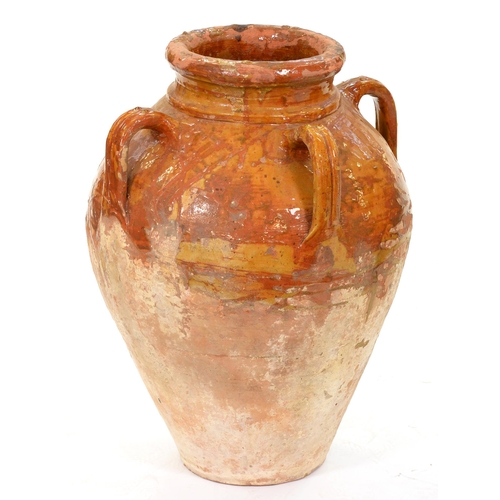 1036 - A Mediterranean lead glazed buff earthenware oil jar, 61cm h