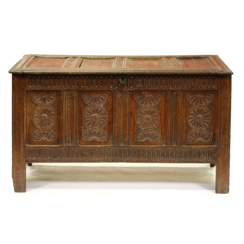 1377 - A Charles II oak chest,  with four panel lid, the conforming front with nulled frieze and rail flank... 