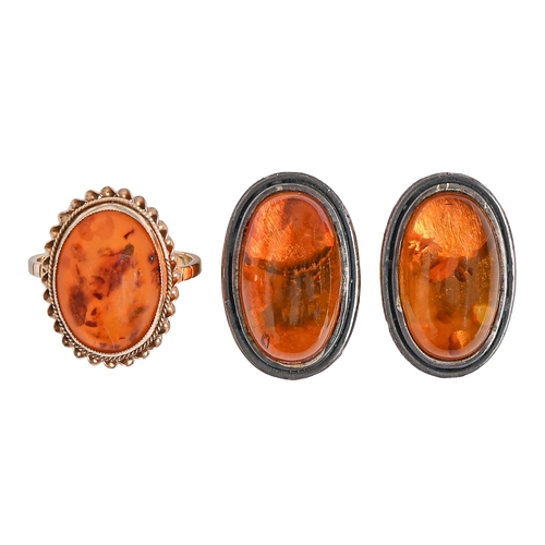 56 - An amber ring, in 9ct gold, Birmingham 1992, 2.8g, size N and a pair of amber ear clips in silver (2... 