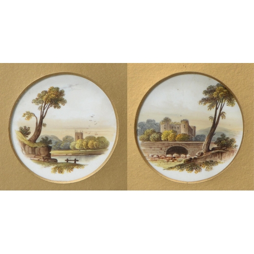 574 - A pair of framed Rockingham plate-centres, c1830-42, painted with a landscape, 70mm diam, puce print... 