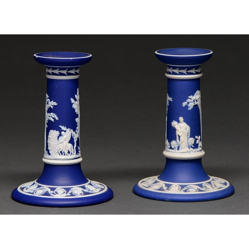 594 - Two Wedgwood dark blue jasper dip candlesticks, late 19th c, sprigged with mythological subjects, 12... 