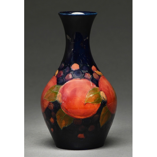 606 - A Moorcroft Pomegranate vase, c1920, 21.5cm h, impressed marks, green painted initials... 