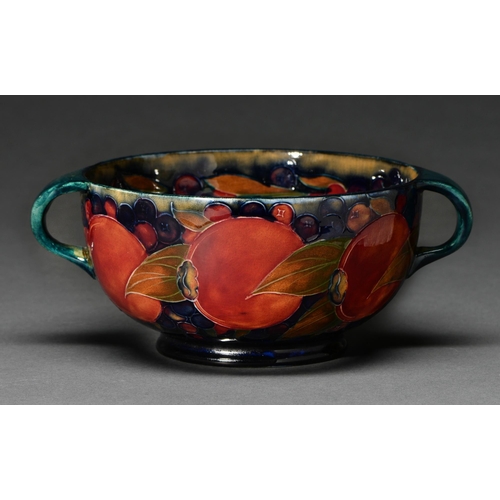 608 - A Moorcroft Pomegranate bowl, c1920, with loop handles, 21cm over handles, impressed mark, green pai... 