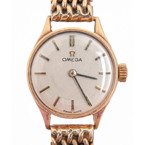 91 - An Omega 9ct gold lady's wristwatch, 19mm diam, Birmingham 1963, on 9ct gold bracelet and deployant ... 