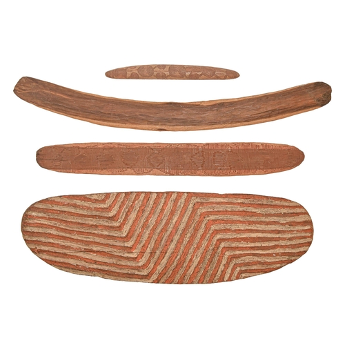 934 -  An Australian aboriginal wood shield, boomerang and two other items, mid 20th c, the front of the s... 