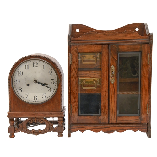 943 - A German oak mantel clock, c1925, with silvered dial and gong striking movement, in arched case, 33c... 