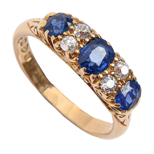 96 - A sapphire and diamond ring, the three sapphires divided by pairs of cushion shaped old cut diamonds... 