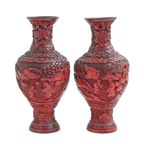 481 - A pair of Chinese cinnabar lacquer vases, late 19th/early 20th c, carved with an immortal and o... 