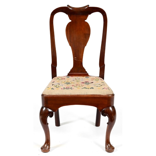 973 - A George II mahogany dining chair, the spoon back with profile splat and paper scroll cresting, havi... 