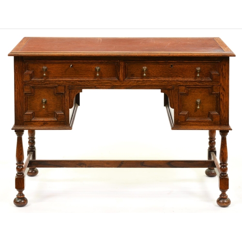 1003 - An oak writing table, early 20th c, the four geometric moulded drawers with brass drop handle, on ba... 