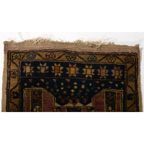 1052 - An antique rug, 112 x 210cm and two other, smaller rugs (3)