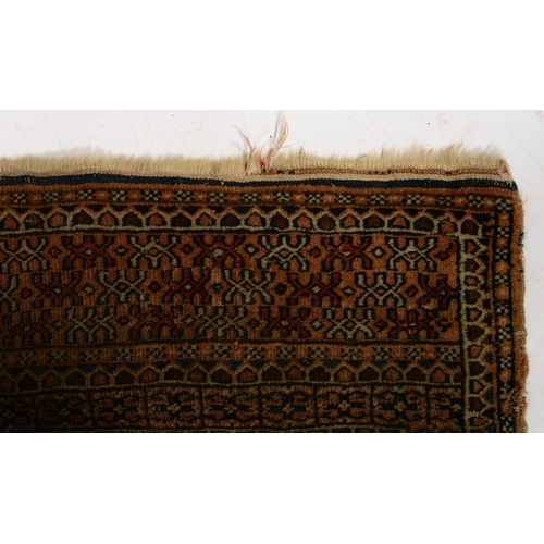 1052 - An antique rug, 112 x 210cm and two other, smaller rugs (3)