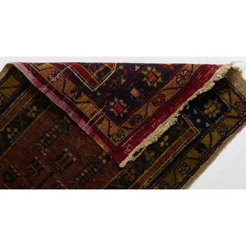 1052 - An antique rug, 112 x 210cm and two other, smaller rugs (3)