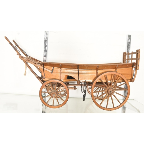 1153 - A scratch built softwood scale model of a hay cart, 20th c, 22.5cm h, 71cm l, a softwood and po... 