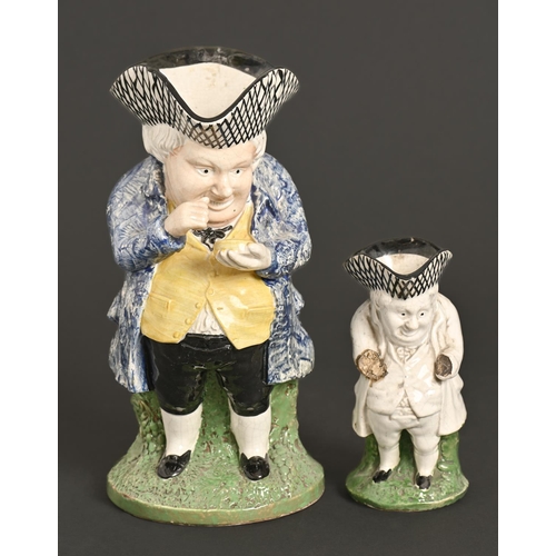 194 - A Staffordshire earthenware snuff taker Toby jug, mid-19th c, sponged in polychrome, 28cm h, an... 