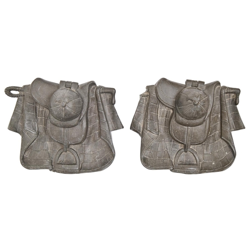 333 - A pair of French bronzed spelter novelty inkwells, late 19th c, in the form of a saddle, stirrup, bl... 