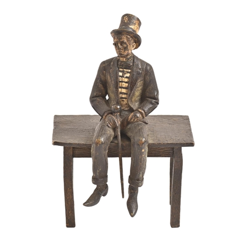 393 - A cold painted Vienna bronze statuette of a man seated on a table, Bergman Foundry, 20th c, 13.5cm h... 