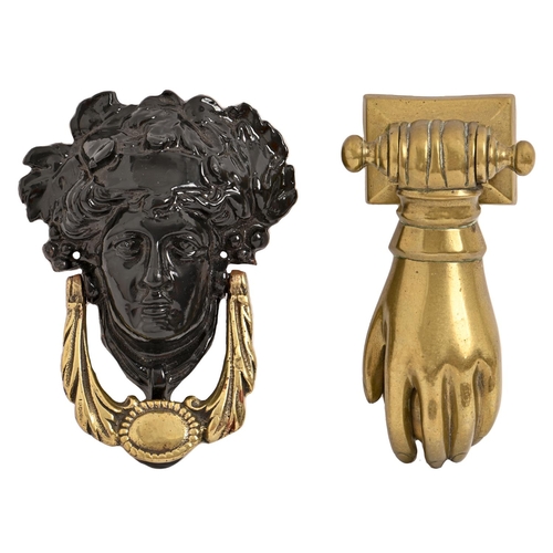 421 - A Victorian brass lady's hand door knocker and a Victorian brass and cast iron mask door knocker, 17... 