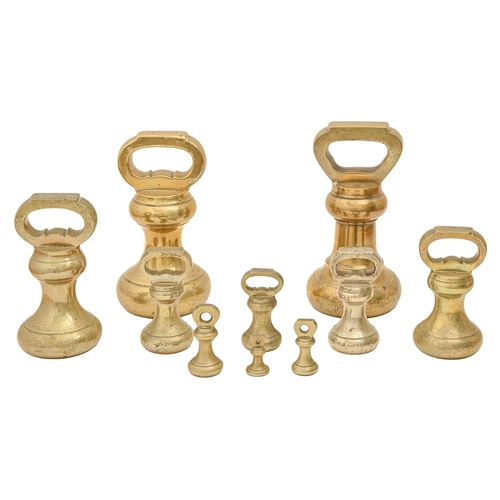 448 - Two English brass 14 lbs bell weights and eight others, late 19th / early 20th c, 2ozs - 7 lbs (10)... 