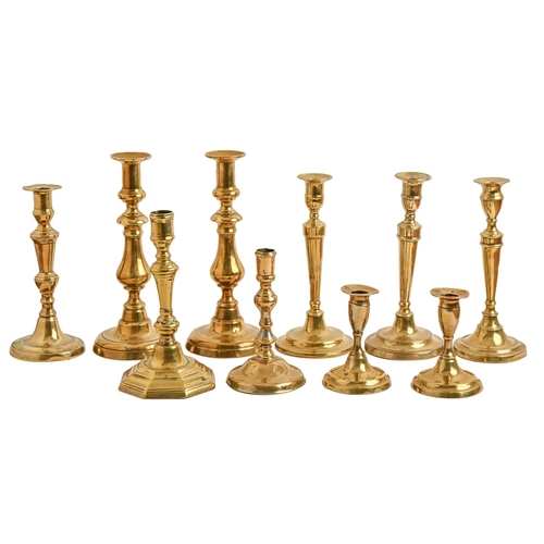 457 - Five English brass candlesticks, mid 18th-early 19th c, one on octagonal foot, one other, a pai... 