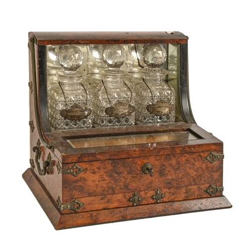 498 - A Victorian brass mounted walnut tantalus, with three cut glass decanters and stoppers and plated la... 