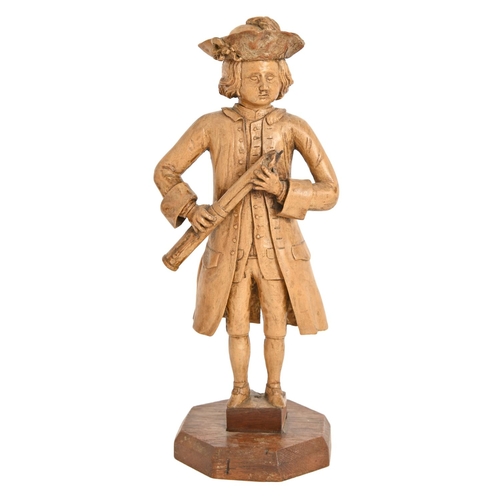 528 - An 18th c softwood carving of a musician, probably German or Austrian, holding a bassoon, weari... 