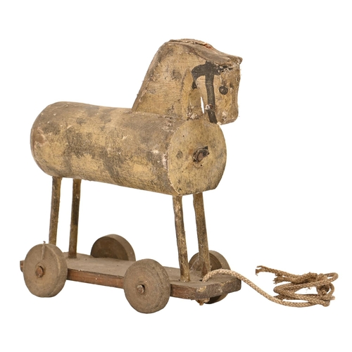 534 - Folk Art. A 19th c softwood child's horse on wheels toy, jointed construction, traces of polych... 