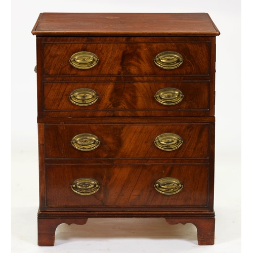 867 - A George IV mahogany cupboard, adapted from a chest commode with later brass oval loop and cup handl... 