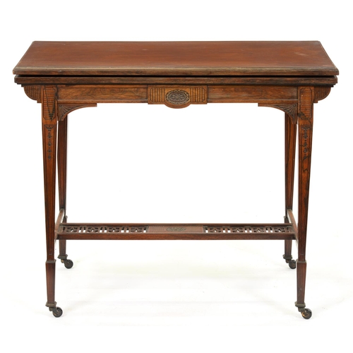 883 - A late Victorian rosewood card table, on square tapered legs with pierced stretcher, pottery castors... 