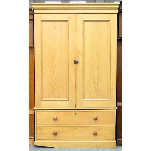 961B - A waxed pine wardrobe, with panelled doors and two drawer base, 212cm h; 52 x 126cm