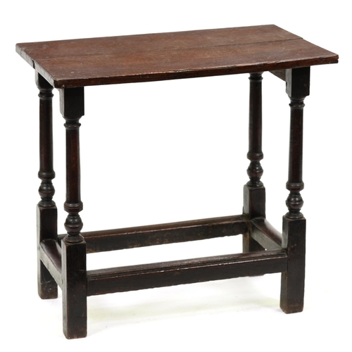 999 - An oak side table, part 18th c, the oversailing top on turned legs united by stretchers, 64cm h; 39 ... 