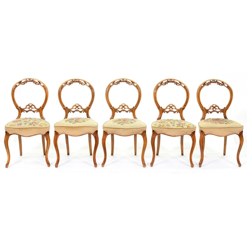 1205 - A set of five Victorian carved walnut dining chairs, on cabriole legs, with later floral woolwork co... 