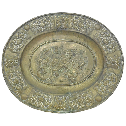 1020 - A Continental sheet brass dish, late 19th c, in 17th c style, embossed to the centre with lion hunte... 