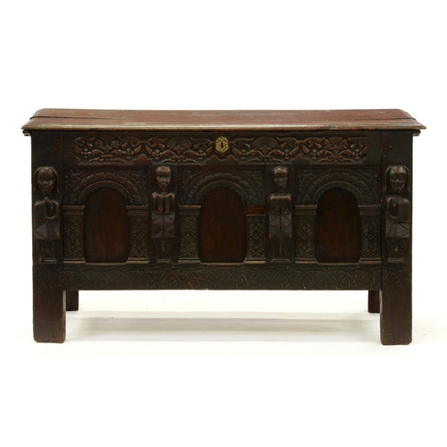 1240 - An oak chest, 17th c and later, the carved arcaded front with demi-figure appliques, on stiles, the ... 