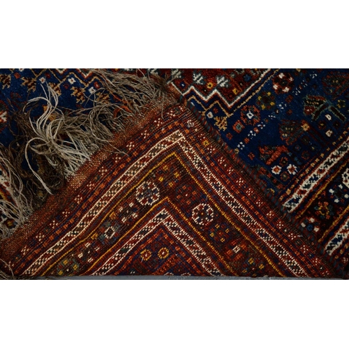 1250 - A Persian style rug, 20th c, blue ground with geometric motifs in earthy tones, 240 x 170cm... 