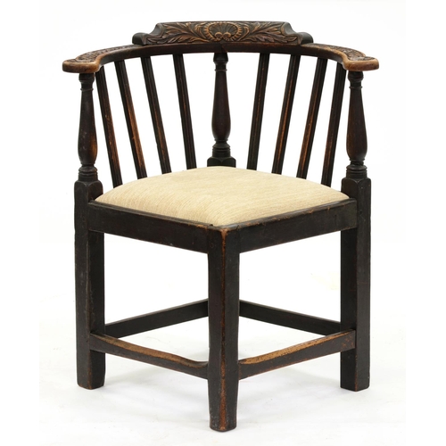 1256 - A George III oak corner chair, the carving late 19th c