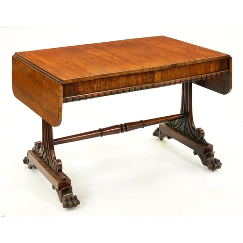 1298 - A William IV rosewood sofa table, on carved double scroll uprights with stretcher, the paw feet with... 