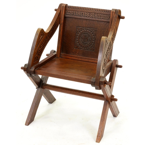 1299 - A Victorian carved oak 'Glastonbury' chair, of typically substantial pegged construction, the panel ... 