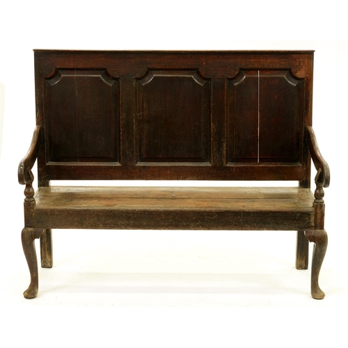 1301 - A George III oak settle, the slightly raked back with three raised and fielded panels, the boarded s... 