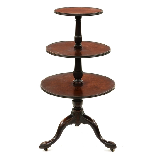 1309 - A George III mahogany dumb waiter, the three finely figured trays rotating around the vase knopped s... 