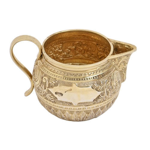 349 - A Victorian silver gilt cream jug, chased with bands of foliage, 60mm h, markers mark rubbed, London... 