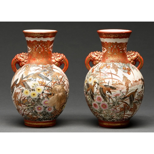 582 - A pair of Japanese earthenware vases, Meiji period, enamelled with birds and flowers between iron re... 