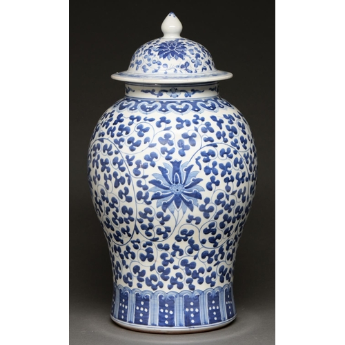 588 - A Chinese blue and white jar and cover, 20th c, painted in Ming style with lotus meander... 