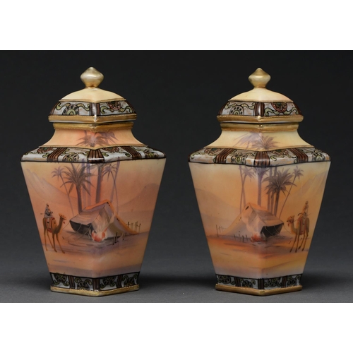 607 - A pair of Noritake vases and covers, c1930, painted with continuous desert scenes, 18cm h, printed m... 